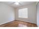 Bright bedroom featuring hardwood floors, a ceiling fan, and a closet with doors that fold open at 2338 E Javelina Ave, Mesa, AZ 85204