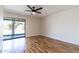 Bedroom featuring hardwood floors and a glass sliding door for backyard access at 2338 E Javelina Ave, Mesa, AZ 85204