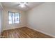 Bright bedroom featuring hardwood floors, a ceiling fan, and a view of the outdoors at 2338 E Javelina Ave, Mesa, AZ 85204