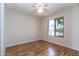 Bright bedroom featuring hardwood floors, a ceiling fan, and a view of the outdoors at 2338 E Javelina Ave, Mesa, AZ 85204