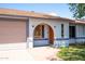 Front exterior featuring desert landscaping, an arched entryway, a garage, and updated fixtures at 2338 E Javelina Ave, Mesa, AZ 85204