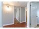 Hallway leading to bedrooms with hardwood floors and neutral wall paint at 2338 E Javelina Ave, Mesa, AZ 85204