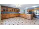 Expansive kitchen featuring wooden cabinetry, granite countertops, tile flooring, and stainless steel appliances at 2338 E Javelina Ave, Mesa, AZ 85204