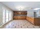 Expansive kitchen featuring wooden cabinetry, granite countertops, tile flooring, and stainless steel appliances at 2338 E Javelina Ave, Mesa, AZ 85204