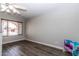 Bright living room featuring a large window with gray walls and dark wood flooring at 2338 E Javelina Ave, Mesa, AZ 85204
