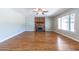 Inviting living room with hardwood floors, a brick fireplace, and a ceiling fan at 2338 E Javelina Ave, Mesa, AZ 85204