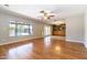 Spacious living room with hardwood floors, large windows overlooking the pool, and natural light at 2338 E Javelina Ave, Mesa, AZ 85204
