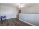 Bright living room featuring modern gray walls and dark wood flooring and a ceiling fan with lights at 2338 E Javelina Ave, Mesa, AZ 85204