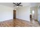 Bright main bedroom with hardwood floors, ceiling fan, and ensuite bathroom access at 2338 E Javelina Ave, Mesa, AZ 85204