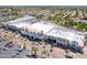 Aerial view of a bustling outdoor retail center, showcasing its attractive architecture, palm trees and ample parking at 2338 E Javelina Ave, Mesa, AZ 85204