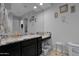 Well-lit bathroom featuring a granite countertop, a large mirror, and ample storage space at 27667 W Mohawk Ln, Buckeye, AZ 85396