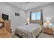 Comfortable bedroom with ceiling fan, carpet, and lamps at 27667 W Mohawk Ln, Buckeye, AZ 85396