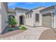 Front exterior showcases desert landscaping and an entrance courtyard at 27667 W Mohawk Ln, Buckeye, AZ 85396