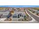 An aerial view showcasing the home's charming elevation, desert landscaping, and brick driveway at 27667 W Mohawk Ln, Buckeye, AZ 85396