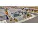 A stunning high angle view showcases the home's facade, desert landscaping, and convenient two car garage at 27667 W Mohawk Ln, Buckeye, AZ 85396