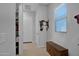 Entryway with built in bench, storage closet, and tile floors at 27667 W Mohawk Ln, Buckeye, AZ 85396
