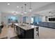 Gourmet kitchen with a spacious island, stainless steel appliances, and open floor plan at 27667 W Mohawk Ln, Buckeye, AZ 85396