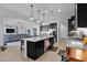 Open kitchen features granite countertops, a large island, and stainless steel appliances at 27667 W Mohawk Ln, Buckeye, AZ 85396