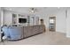 Bright living room featuring a large sofa, recessed lighting, and neutral decor at 27667 W Mohawk Ln, Buckeye, AZ 85396