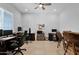 Spacious home office featuring a ceiling fan and multiple workstations at 27667 W Mohawk Ln, Buckeye, AZ 85396