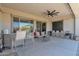 Covered patio with outdoor bar and large sliding glass doors to the interior at 27667 W Mohawk Ln, Buckeye, AZ 85396