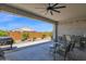 Covered patio with outdoor kitchen, ceiling fan, and a gas grill at 27667 W Mohawk Ln, Buckeye, AZ 85396