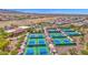 Aerial view of a community's multiple outdoor pickleball courts, well-maintained and ready for active fun at 27667 W Mohawk Ln, Buckeye, AZ 85396