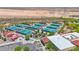 An aerial view highlighting the tennis and pickleball courts in a desert community at 27667 W Mohawk Ln, Buckeye, AZ 85396