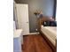 View of a cozy bedroom with wood floors, featuring a bed and a lamp at 2929 E Main St # 601, Mesa, AZ 85213