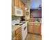 Functional kitchen features classic wood cabinets, white appliances, and ample counter space at 2929 E Main St # 601, Mesa, AZ 85213