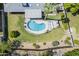Overhead view of a backyard with a kidney-shaped pool, covered patio, mature landscaping, and a well-maintained lawn at 314 E Royal Palm Rd, Phoenix, AZ 85020