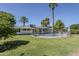 Spacious backyard showcasing a fenced pool, lush green lawn, mature trees, and a single-story home's rear exterior at 314 E Royal Palm Rd, Phoenix, AZ 85020