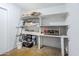 Unfinished basement with organized storage shelves, painted cinderblock walls, and concrete floors, offering versatile space at 314 E Royal Palm Rd, Phoenix, AZ 85020