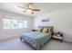 Bright bedroom features a large window, ceiling fan, and stylish mid-century modern bedside tables at 314 E Royal Palm Rd, Phoenix, AZ 85020