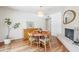 Cozy dining room featuring a round table set, light wood floors, and a stylish fireplace with mantle at 314 E Royal Palm Rd, Phoenix, AZ 85020