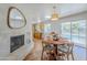 Open dining area features a fireplace, hardwood floors, and backyard views at 314 E Royal Palm Rd, Phoenix, AZ 85020