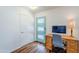 Home office space with built in desk, sleek monitor and stylish teal door at 314 E Royal Palm Rd, Phoenix, AZ 85020