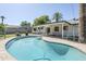 Inviting backyard pool with a patio, lush landscaping, and a fenced-in area at 314 E Royal Palm Rd, Phoenix, AZ 85020