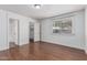 Bright bedroom with wood floors, window, baseboards, closet, and white paint at 343 W Santa Cruz Dr, Tempe, AZ 85282
