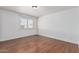 Empty bedroom with wood floors, window, baseboards, and white paint at 343 W Santa Cruz Dr, Tempe, AZ 85282