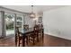 Dining room with hardwood flooring, light fixture, and view of a backyard at 343 W Santa Cruz Dr, Tempe, AZ 85282