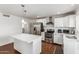Bright kitchen features white cabinets, stainless appliances, and a large island with a quartz countertop at 343 W Santa Cruz Dr, Tempe, AZ 85282