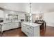 Open concept kitchen with white cabinets, stainless appliances, and a view of the dining area at 343 W Santa Cruz Dr, Tempe, AZ 85282