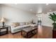 Inviting living room featuring hardwood floors, neutral sectional, and an airy atmosphere at 343 W Santa Cruz Dr, Tempe, AZ 85282