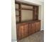 Close up view of rustic built-in shelves and cabinets in a home's living room, for books and décor at 3636 E Parkview Dr, Gilbert, AZ 85295