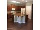 Spacious kitchen featuring wood cabinets, stone countertops and a large kitchen island at 3636 E Parkview Dr, Gilbert, AZ 85295