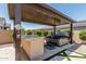 Relaxing backyard with pergola, hot tub, and outdoor bar perfect for entertaining guests at 3948 E Caitlin Dr, San Tan Valley, AZ 85140