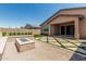 Backyard features an inviting fire pit, artificial turf accents, and a neutral colored home, perfect for outdoor gatherings at 3948 E Caitlin Dr, San Tan Valley, AZ 85140