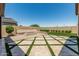 Spacious backyard with desert landscaping, pavers, and a modern gas firepit at 3948 E Caitlin Dr, San Tan Valley, AZ 85140