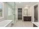Luxurious bathroom featuring a glass shower, soaking tub, and natural light at 3948 E Caitlin Dr, San Tan Valley, AZ 85140